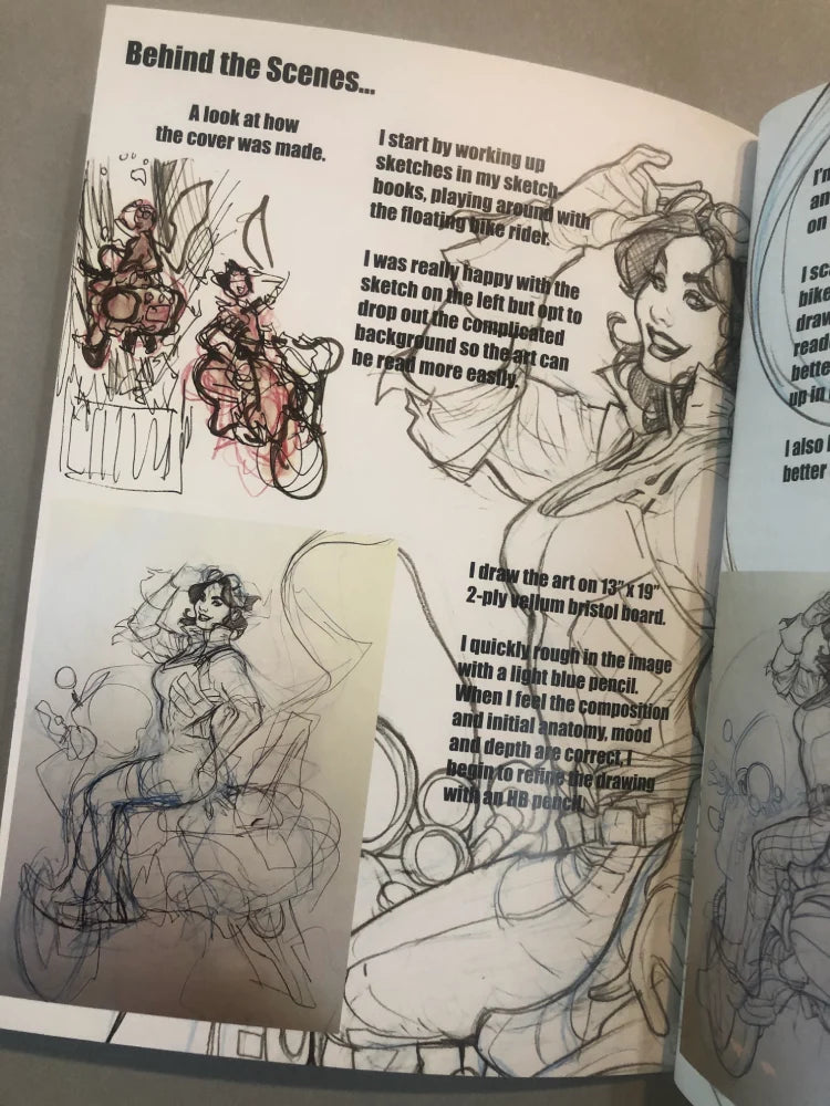 An open sketchbook or art book showing printed pages with black line drawings and handwritten notes about the cover artwork, photographed from above on a neutral surface.