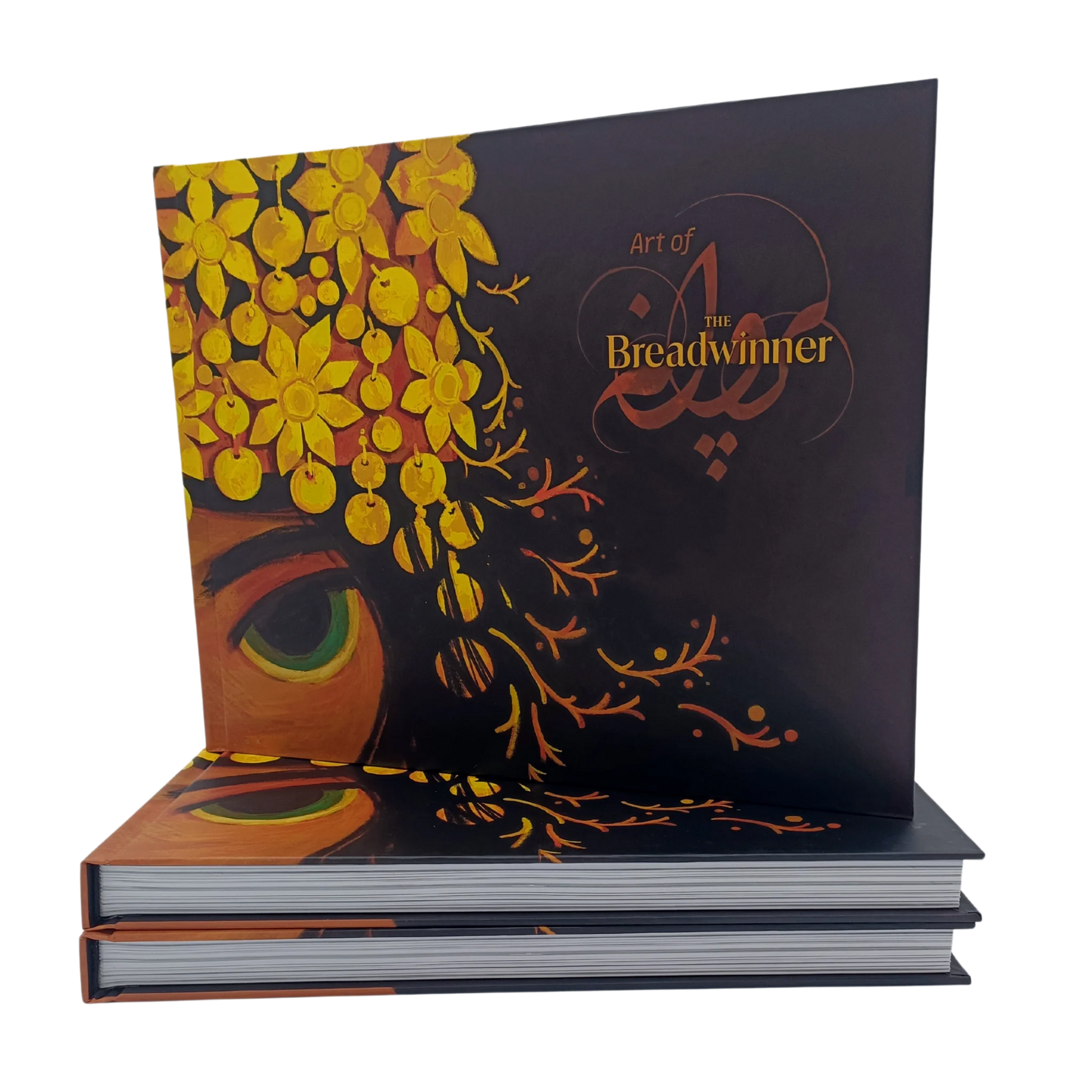Hardcover "Art of The Breadwinner" book cover standing upright, featuring intricate golden floral headpiece artwork and the film title.