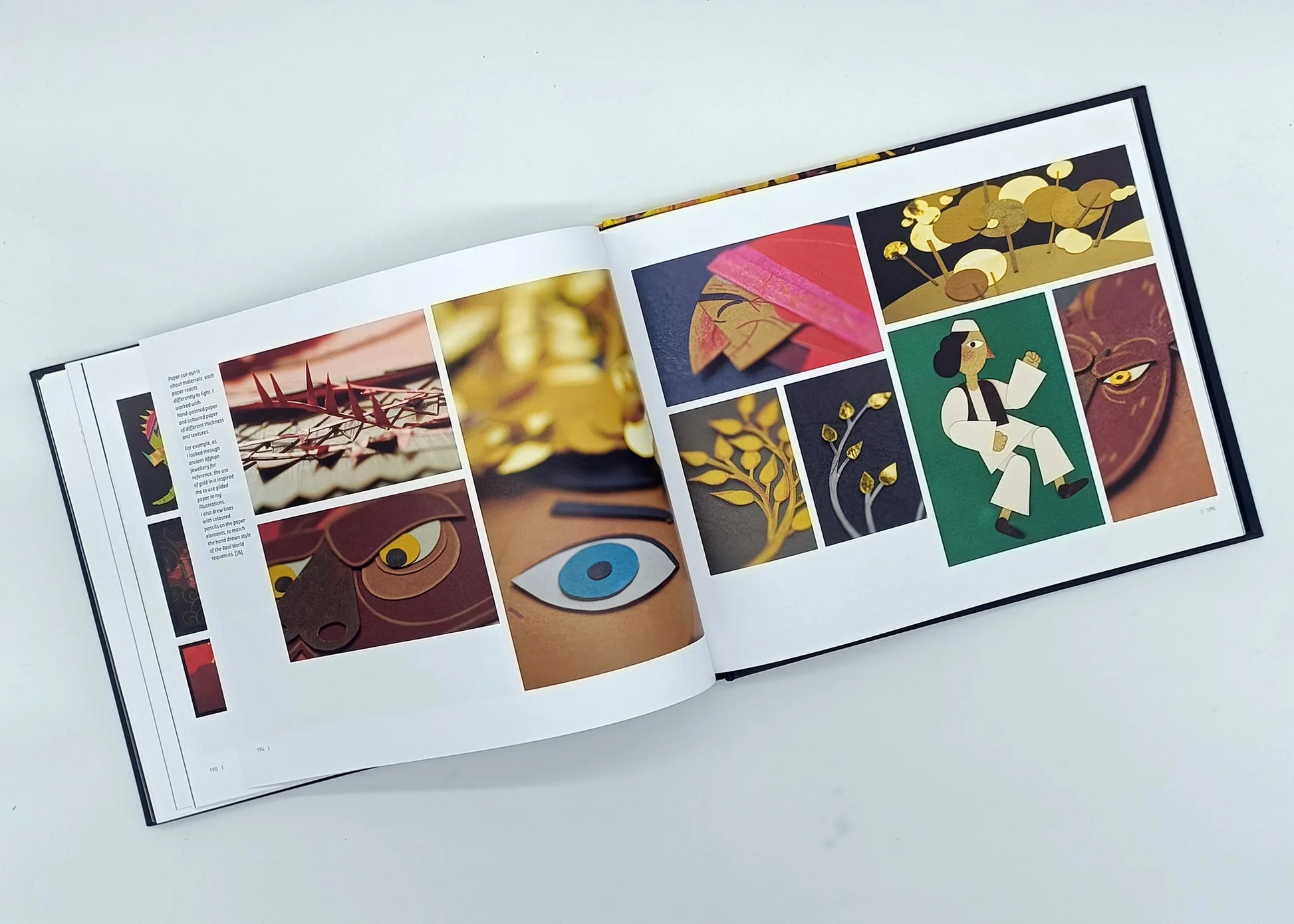 Open pages of "Art of The Breadwinner" book showing detailed concept art, paper cut-out character designs, and illustrations from the animated film.