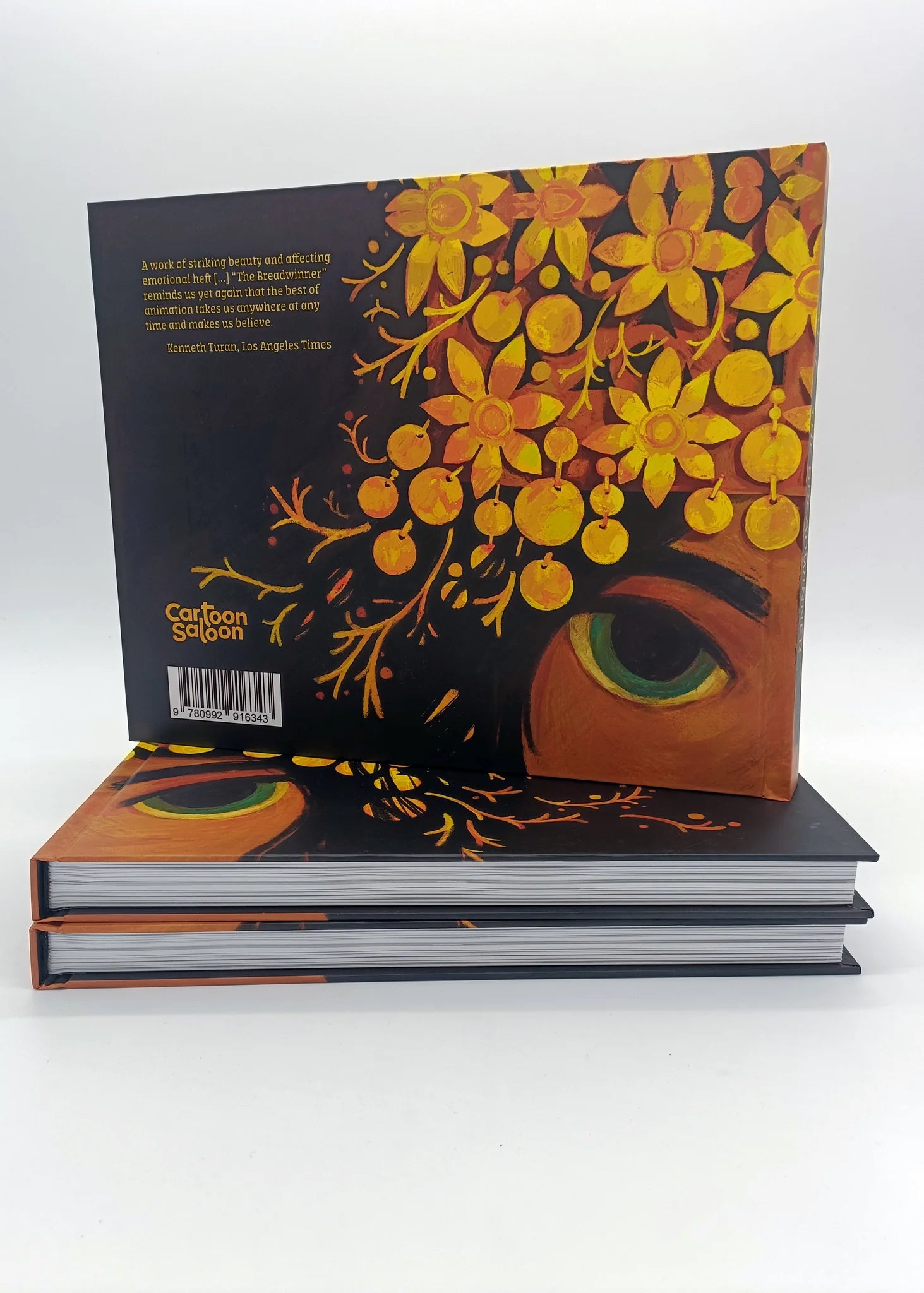Back cover of "Art of The Breadwinner" hardback book by Cartoon Saloon, showing the ISBN barcode and artistic floral illustration.