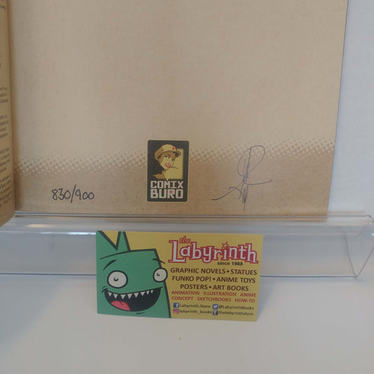 A Contx Buro signed print of 'The Labyrinth' featuring a green monster character, displayed on a clear acrylic stand with a number tag of 830/900.