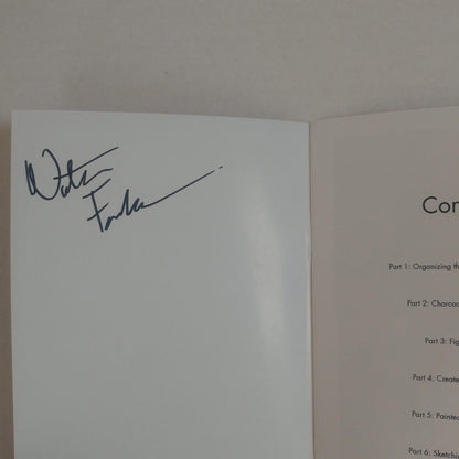 An open book or booklet showing a white signature page with a dark ink signature on the left page and a light beige instruction or table of contents page on the right page.