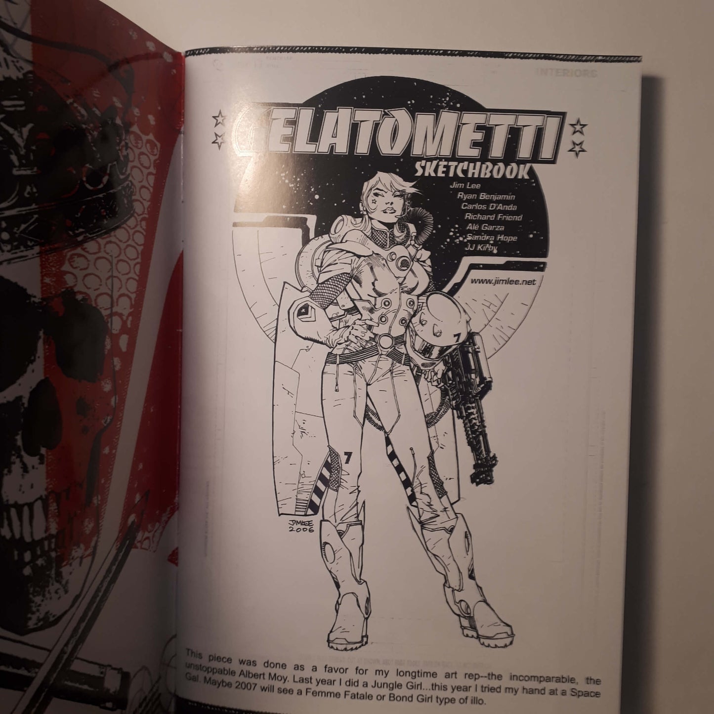 An open sketchbook showing a black-and-white page titled 'GELATOMMETI SKETCHBOOK' with a line drawing of a futuristic armored figure, photographed against a light background.