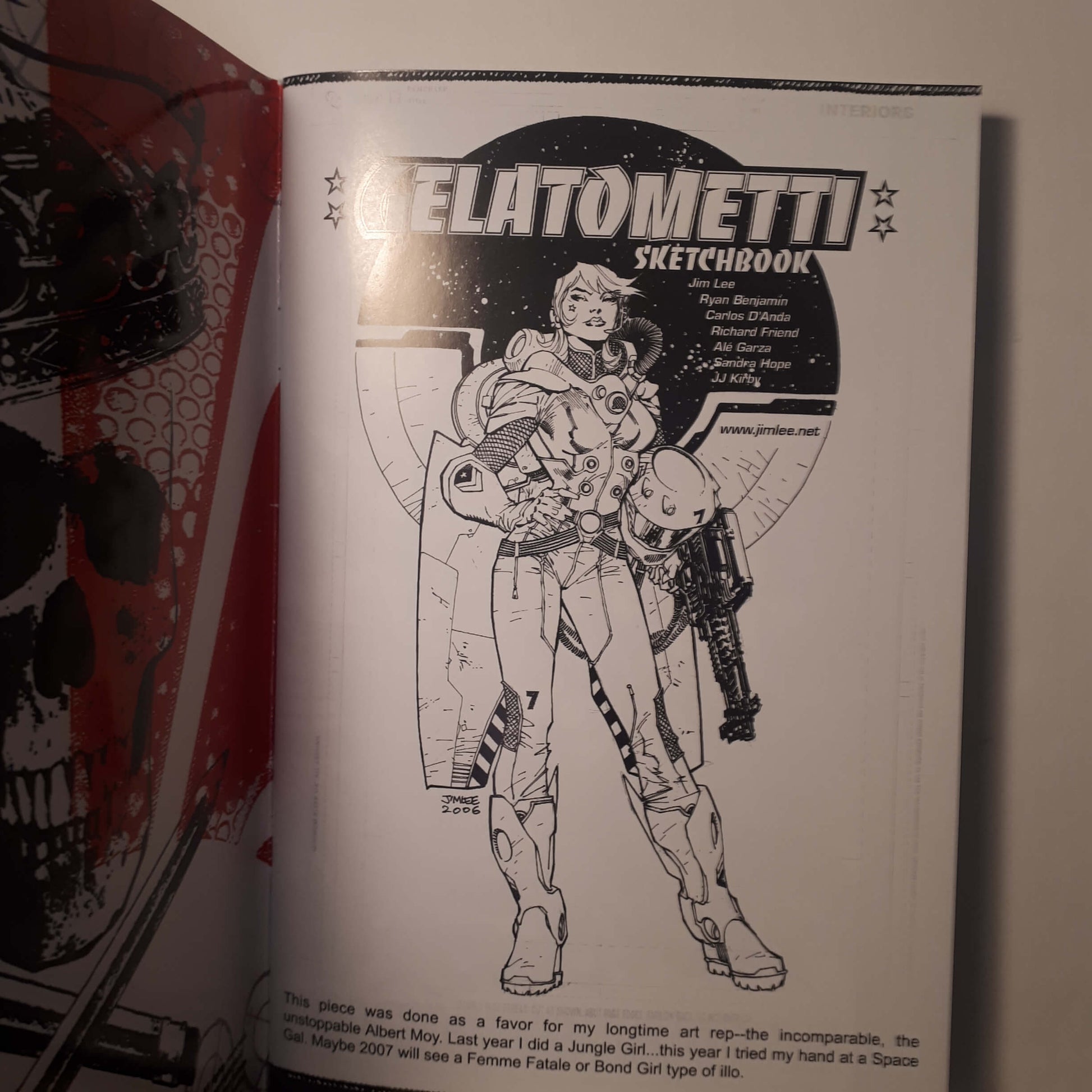 An open sketchbook showing a black-and-white page titled 'GELATOMMETI SKETCHBOOK' with a line drawing of a futuristic armored figure, photographed against a light background.