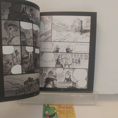 An open black-and-white manga or comic book spread displayed upright on a clear acrylic stand against a light wall. A small green card with the word "Labyrinth" is visible below the stand.
