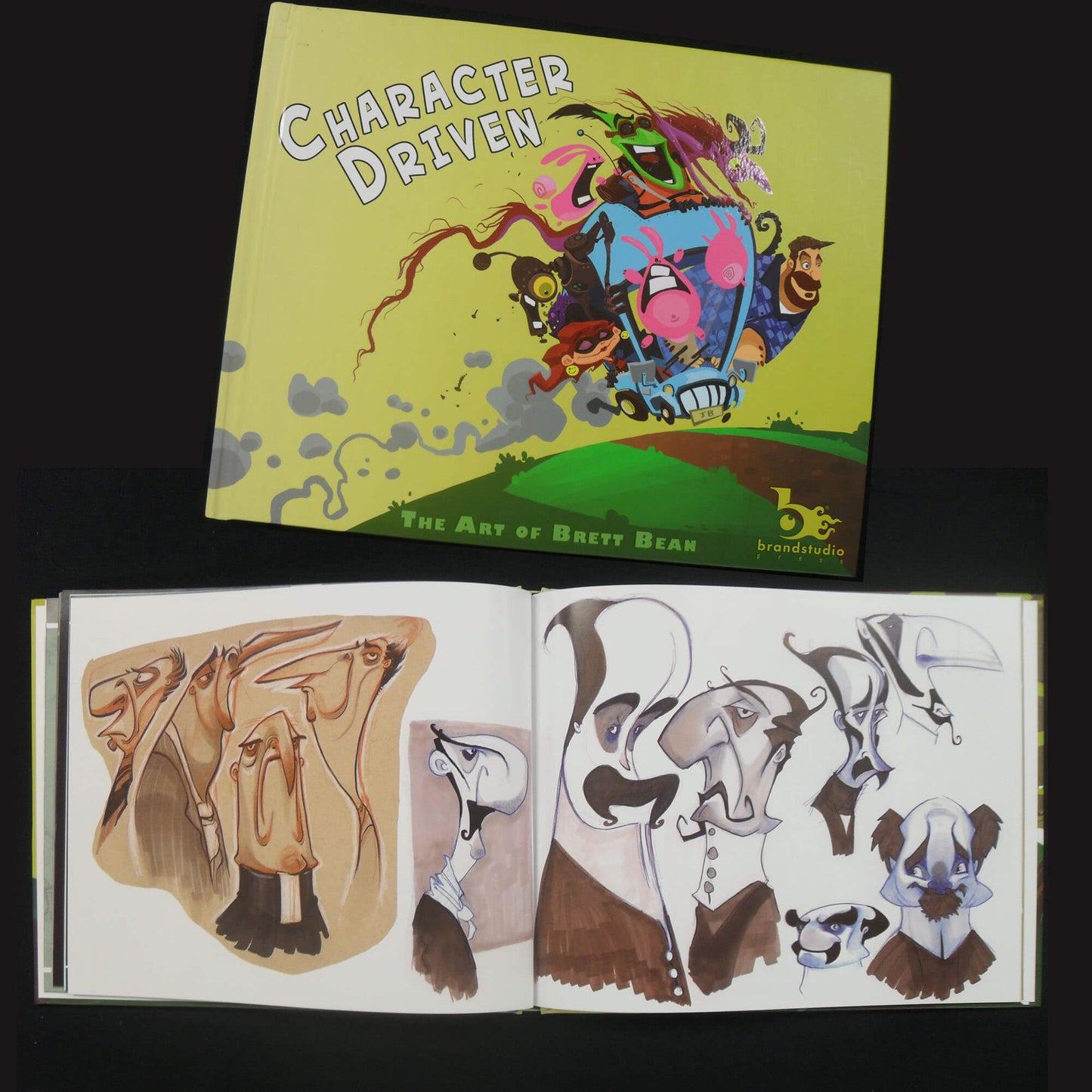 A book or portfolio titled "Character Driven: The Art of Brett Bean" is shown open and closed on a black background. The closed cover features a colorful illustration with a yellow-green background, and the open spread shows character concept sketches and drawings.