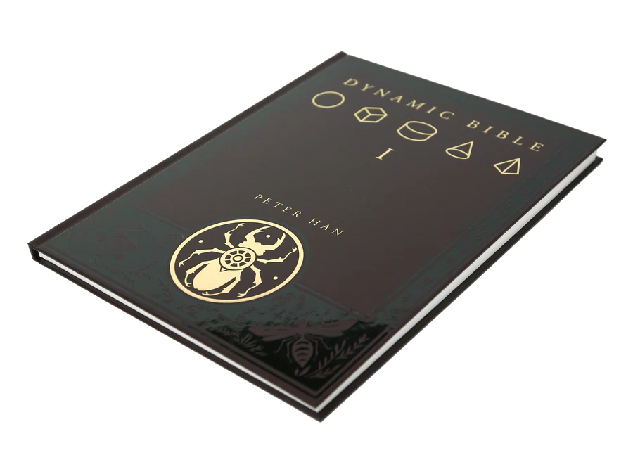 A hardcover book titled 'Dynamic Bible I' by Peter Han, featuring a glossy black cover with gold foil lettering and a gold beetle emblem, shown on a plain white background.