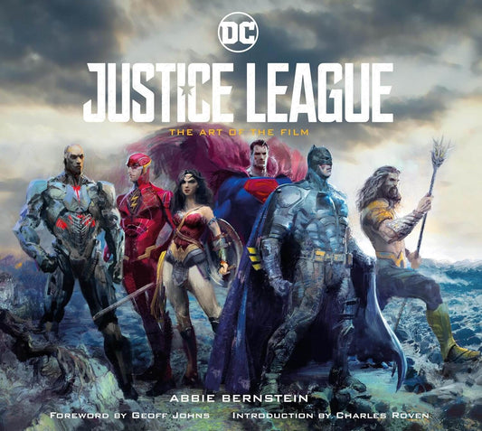 Book cover of 'Justice League: The Art of the Film' featuring superhero characters against a stormy sky.