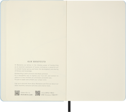Open notebook displaying a manifesto on cream-colored pages.