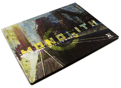 A square art print or book cover titled 'Monolith' with an abstract painted design in dark tones, yellow text, and a small white logo in the bottom right corner, photographed on a white background.