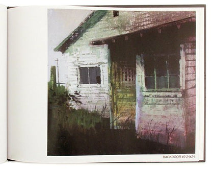 An art print or book page showing a textured painting of a weathered house, with the title 'BACKDOOR #2 24624' printed at the bottom right.