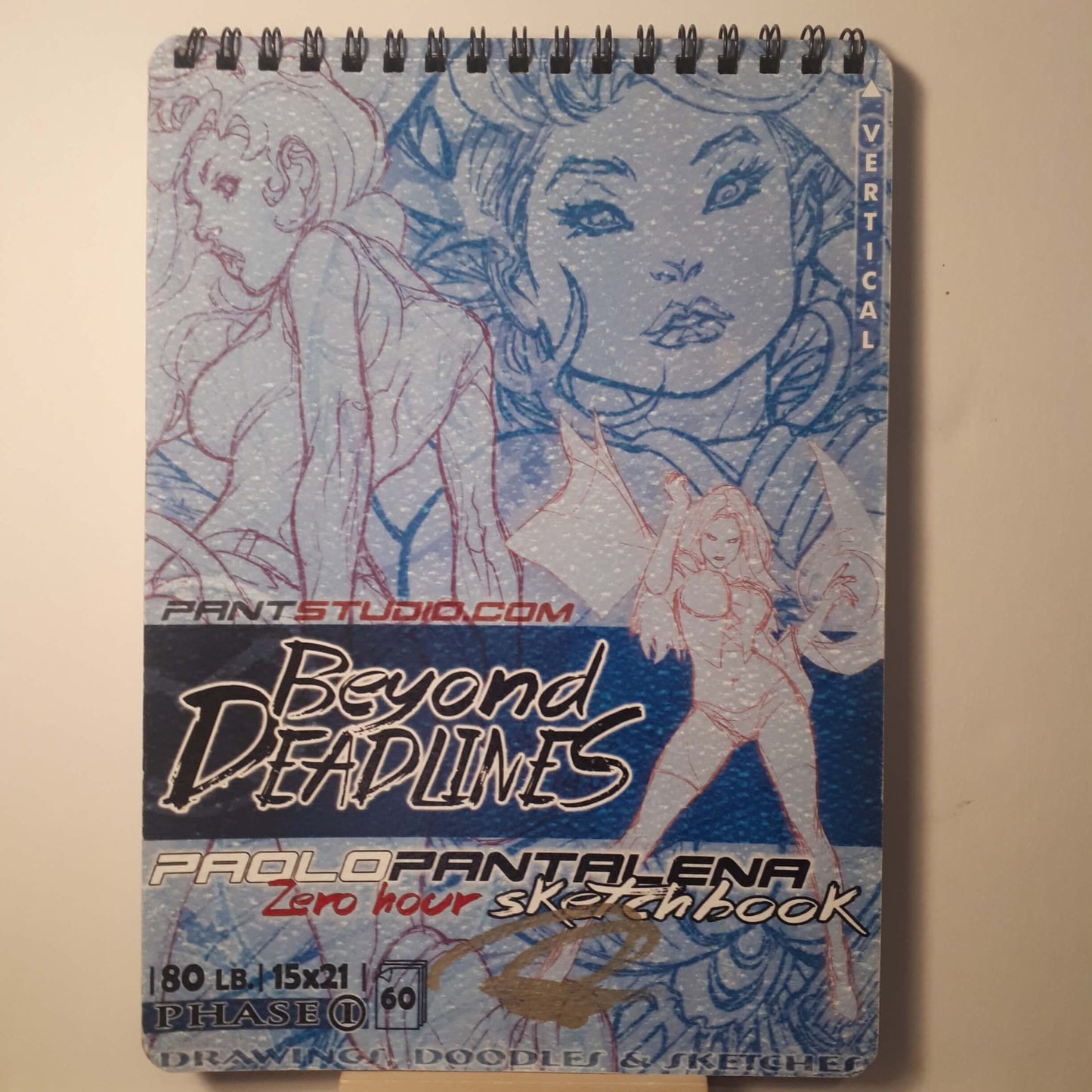 A spiral-bound sketchbook titled 'Beyond Deadlines' by ProloPantelena, featuring blue and white sketch art on the cover, photographed against a plain beige background.