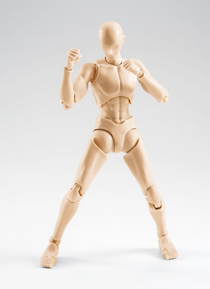 A beige articulated plastic mannequin figure of a female dancer or gymnast, posed in a martial arts stance against a light gray studio background.