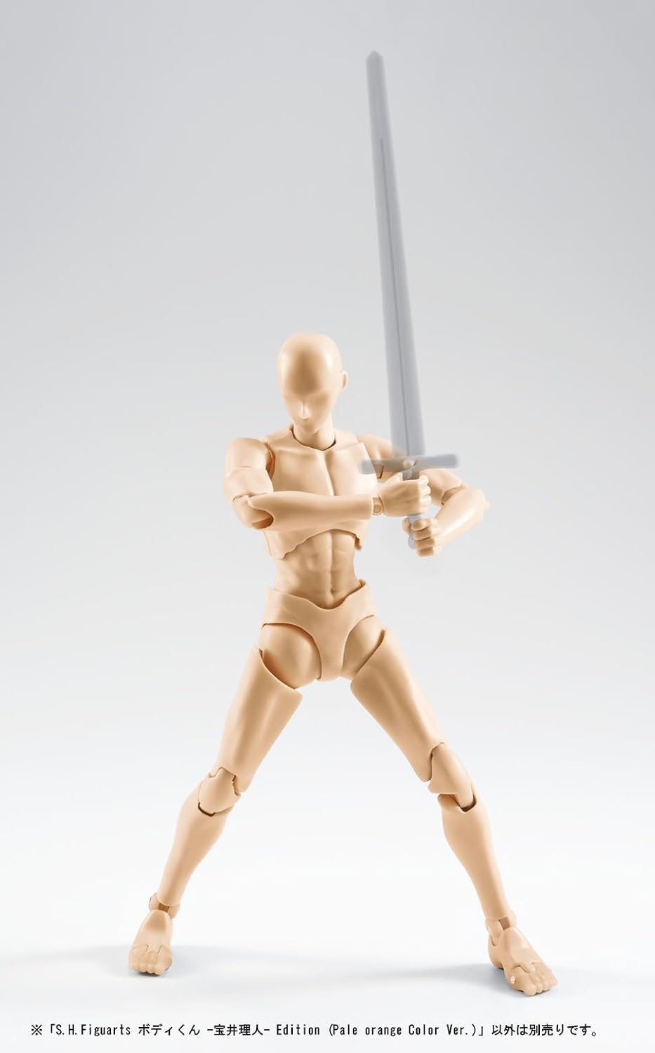 A pale orange articulated human figure posed with a long sword, photographed against a light gray studio background. The figure has a headless, anatomically styled pose with visible joints and musculature.