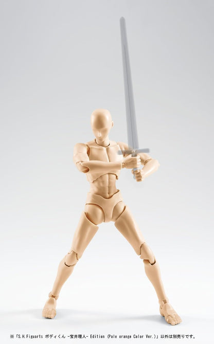 A pale orange articulated human figure posed with a long sword, photographed against a light gray studio background. The figure has a headless, anatomically styled pose with visible joints and musculature.