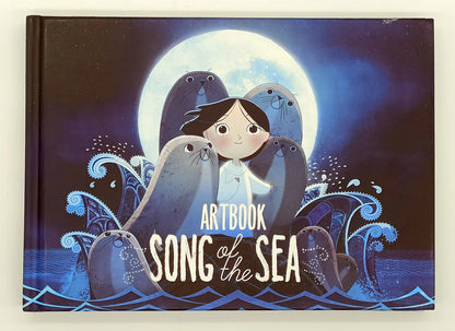 Artbook 'Song of the Sea' with illustration of a girl and seals against a moonlit sky.