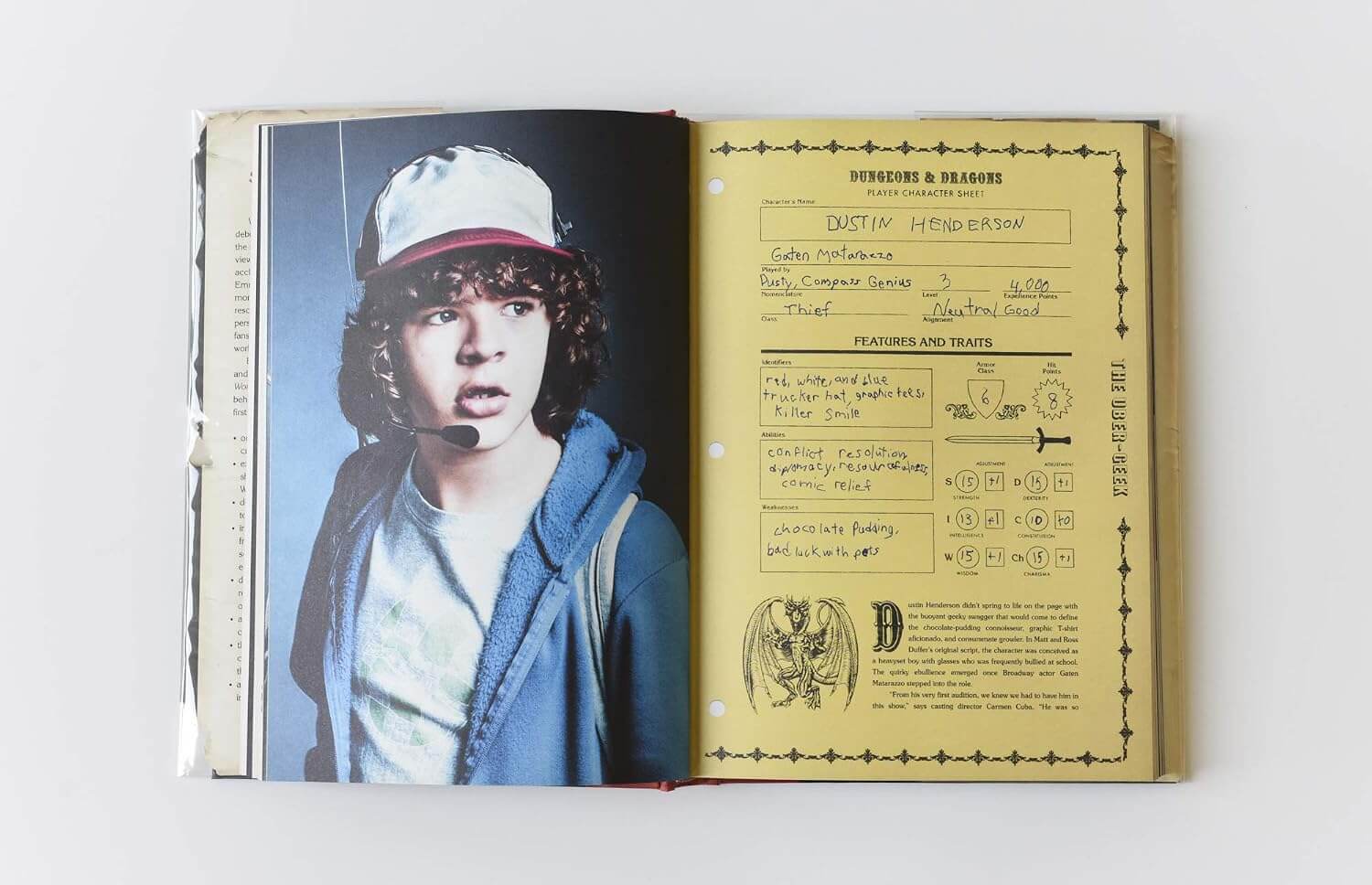 An open book or album cover showing a printed page with a portrait of a person on the left and a yellowed character-style profile sheet with handwritten notes and diagrams on the right.