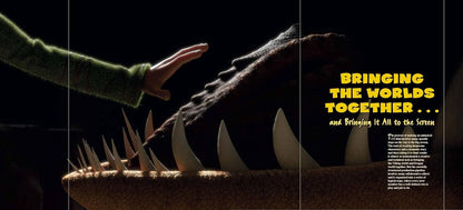 A dark promotional still showing a human hand reaching toward a large creature's open mouth with sharp teeth. Yellow text on the right reads 'BRINGING THE WORLDS TOGETHER.