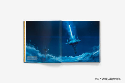 An open hardcover book or art print displaying a blue-toned sci-fi scene with a glowing futuristic structure and dark clouds, photographed against a light gray background. A small Lucasfilm copyright mark appears in the bottom-right corner.