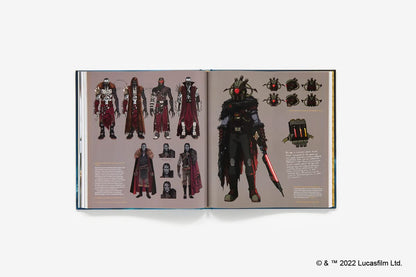 An open book displaying character concept art and costume designs, featuring multiple full-body and partial views of a dark armored warrior with red glowing eyes and a red blade, set against a plain light gray background.
