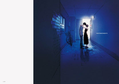 Two people embracing in a dimly lit hallway with a light source at the end.
