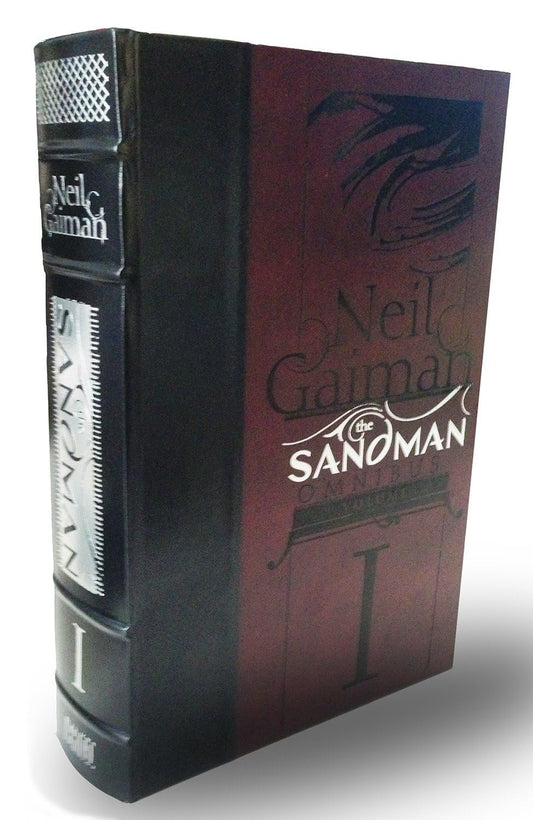 Book titled 'The Sandman' by Neil Gaiman with black and red cover design.